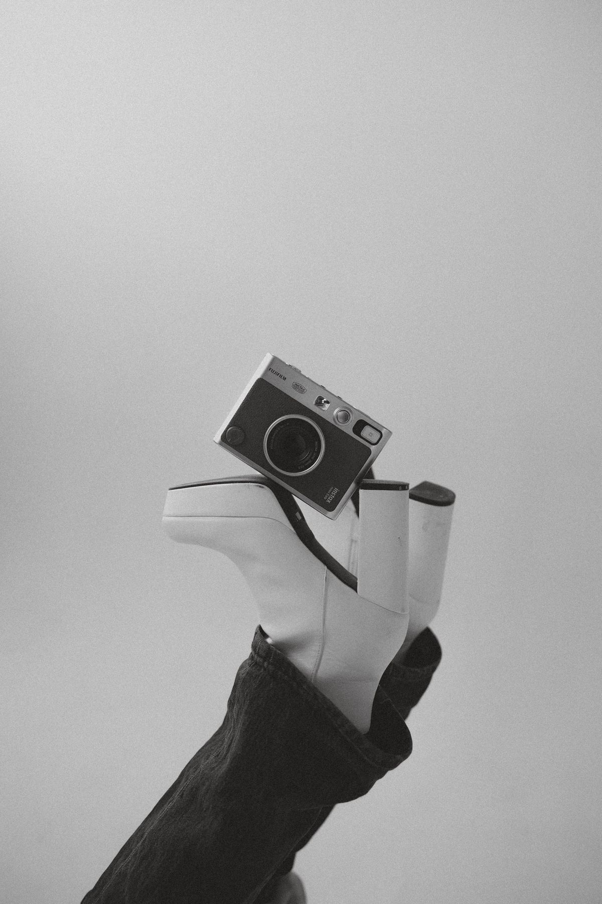 A vintage camera in hand, black and white