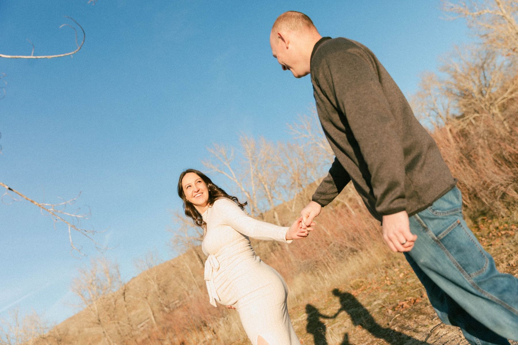 Hand in hand on the hillside under a blue sky