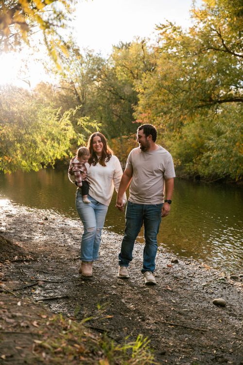 A couple walking the river path in autumn