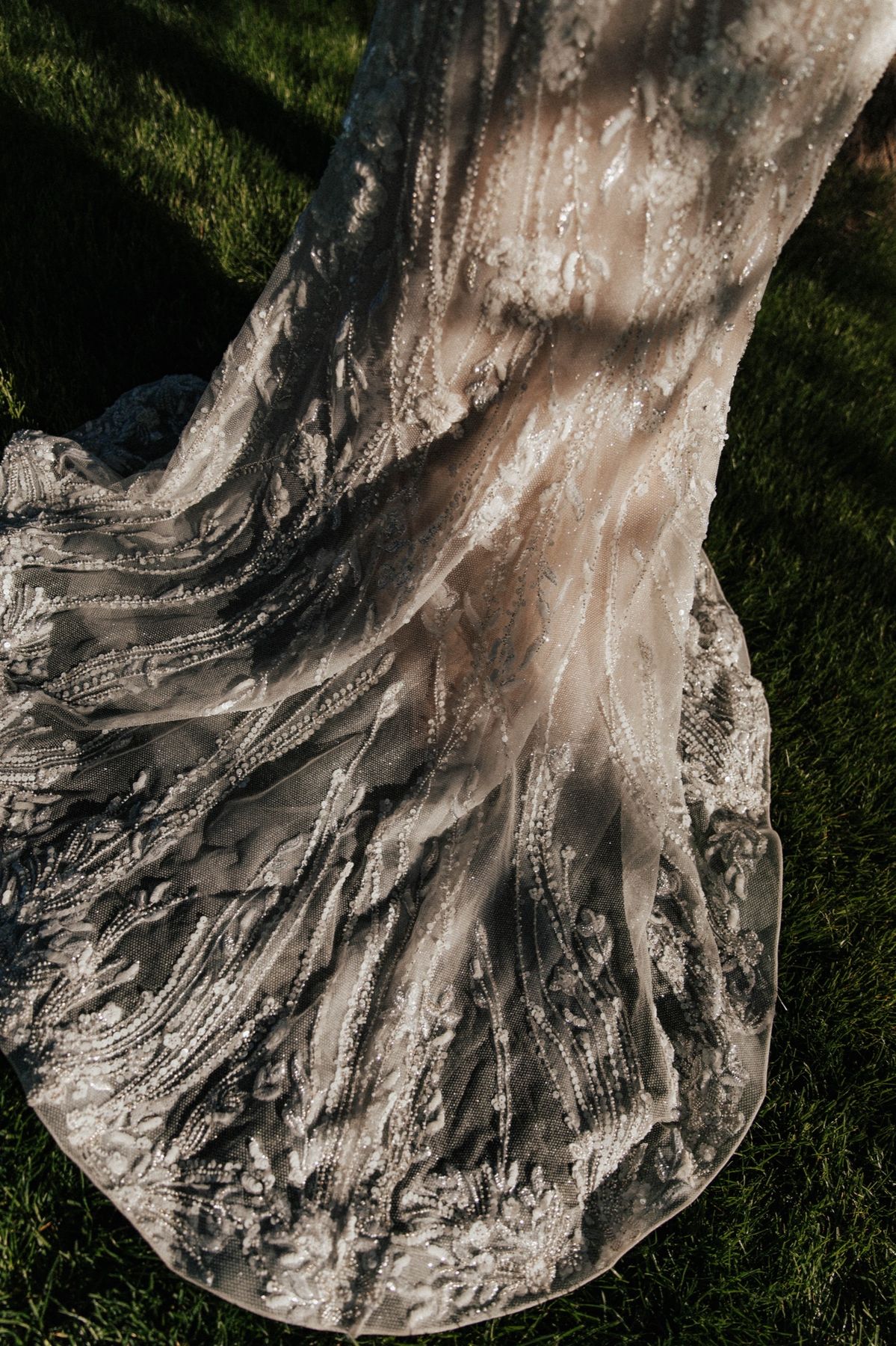 The dress train fanned across the grass